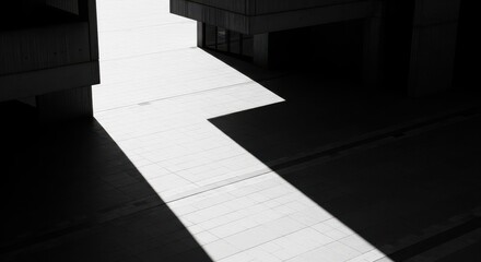 Obraz premium High contrast shadow of a brutalist building on a concrete plaza