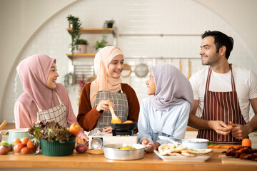 Happy Muslim family cooking in modern Kitchen