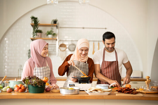 Happy Muslim friends cooking in modern Kitchen