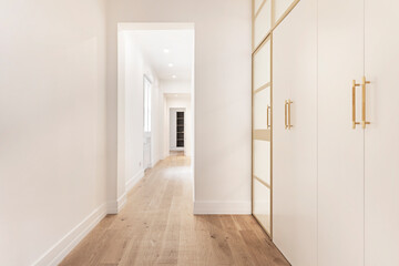 Nordic-style white wardrobe doors with metal details and discreetly etched translucent glass