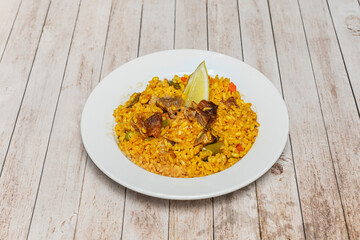 Chicken and artichoke paella, showing how the outer leaves have browned in contact with the pan