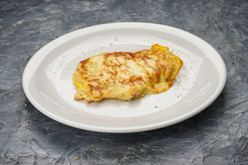 Chicken chop in a white plate on a gray concrete background