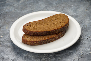 two slices of brown bread in a white plate on a background