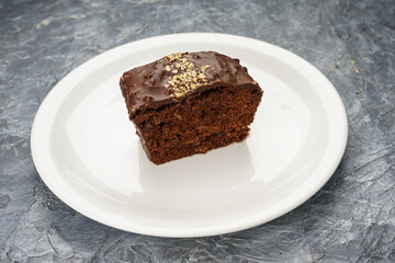 dessert sachertorte cake in a white plate on a gray background