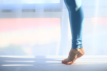 The girl is standing on her toes, legs in close-up