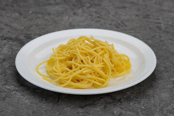 cooked spaghetti pasta in a white plate macro photo