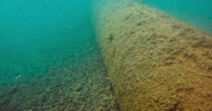 Large diameter underwater pipeline on the seabed.