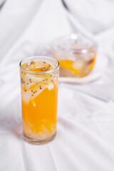 a glass off orange juice with coconut and cia seed. Served cold and isolated from white background. Perfect for recipe, article, catalogue, promotion, or any cooking contents