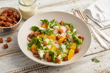 Caesar salad with orange and radishes