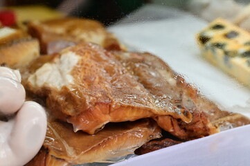 Traditional Taiwanese smoked shark jerky (sha yu xun), popular seafood delicacy with chewy texture, commonly served at noodle stalls and local eateries.