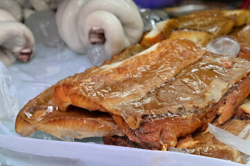 Traditional Taiwanese smoked shark jerky (sha yu xun), popular seafood delicacy with chewy texture, commonly served at noodle stalls and local eateries.