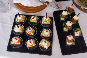 Delicious assorted appetizers served on elegant platters at a culinary event in a modern setting during daylight hours