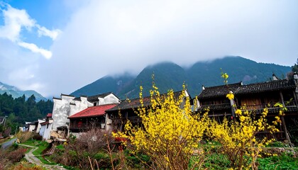 A picturesque village nestled in a valley, showcasing traditional architecture, vibrant yellow flowers, and a misty mountain backdrop.