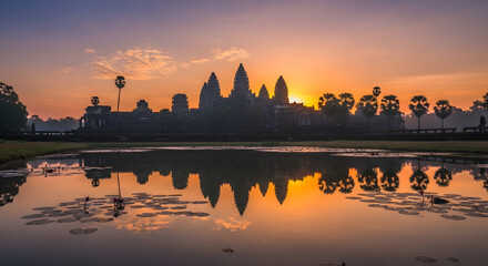 Fototapeta premium Sunrise reflection over angkor wat temple siem reap photography tranquil scenic landscape