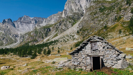 Beautiful mountain landscape with a traditional mountain hut with piode or beole, the local term for stone slab roofs in the Alpe Devero National Park, Piedmont, Italy