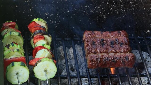 cevapcici and vegetable skewers on grill

