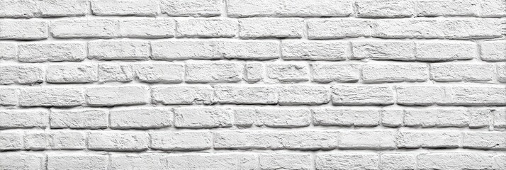 A close-up view of a white brick wall.  The regular pattern of rectangular bricks is clearly visible