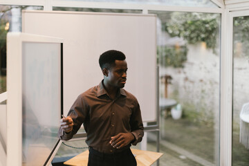 Businessman giving presentation using whiteboard in modern office