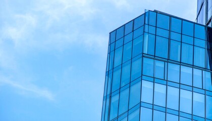 Obraz premium Modern glass architecture with sharp lines and reflective surfaces, illuminated by natural daylight for a sleek aesthetic