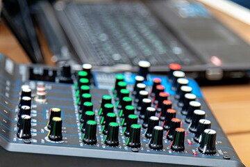 This image shows a close-up of a digital audio workstation DAW control surface which is a type of hardware used to control software for recording editing and producing music or other audio content