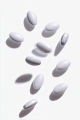 White pills in mid-air, casting shadows