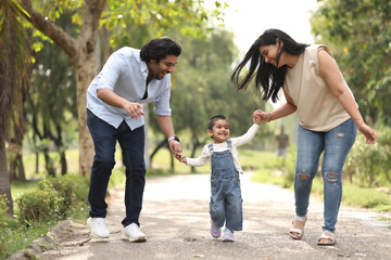 Fototapeta premium Family Takes A Happy Walk In The Sun