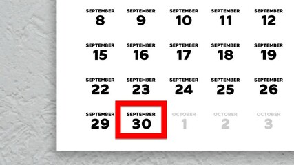 The date September 30th marked with a red cursor on the wall calendar 2025