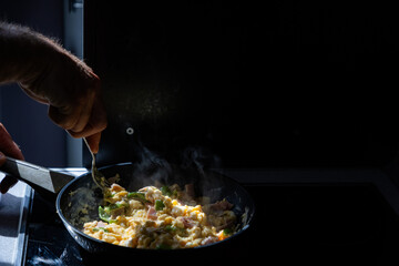 preparing scrambled eggs in the morning