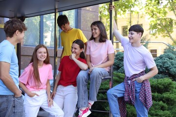 Group of happy teenage friends spending time together outdoors