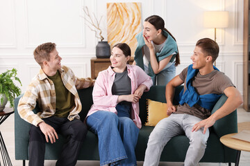 Fototapeta premium Friends laughing on sofa indoors. Positive emotion