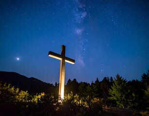 Illuminated cross under starry night sky