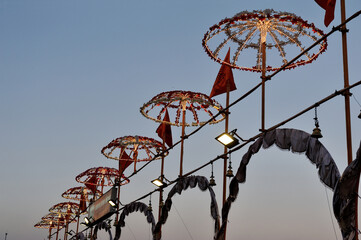 Row of Chhatri (decorative illuminated umbrellas) for Ganga Aarti ritual in Varanasi, India. 