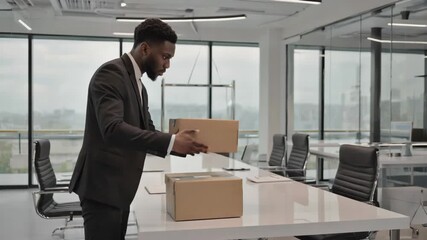 Business professional organizing packages in modern office space