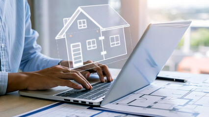 Person designing modern home blueprint with digital house overlay on laptop screen, planning future construction.