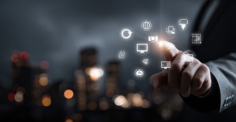 A hand interacts with digital icons over a city skyline