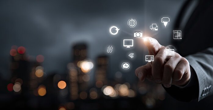 A hand interacts with digital icons over a city skyline