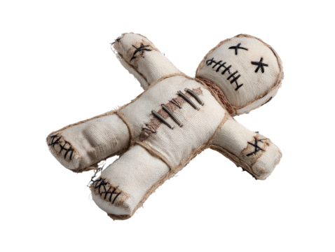 Handmade burlap voodoo doll with stitched eyes and mouth twine bindings and metal staples on its chest.
