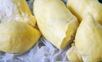 A yellow durian that has been peeled off to reveal the tasty yellow flesh of the durian. Close-up