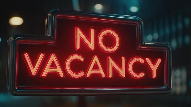 No Vacancy Neon Sign: An eye-catching neon sign boldly proclaims NO VACANCY against a blurred backdrop, capturing a sense of closure and unavailability.