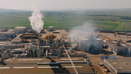 Wood chip processing plant emitting smoke and steam