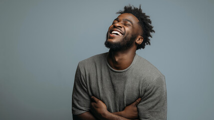 A high-quality image portraying joyful guy with neat beard, wearing a spirited t-shirt, flashing a warm grin, revealing chin, cheeks, and jawline details.