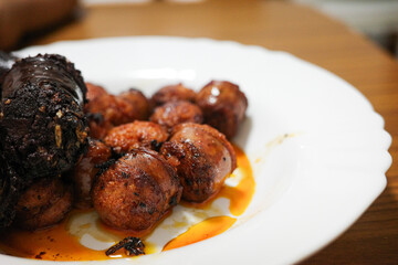 Spanish chorizo and blood sausage served on a white plate