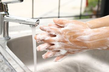 Fototapeta premium Wash your hands to prevent germs for good health.