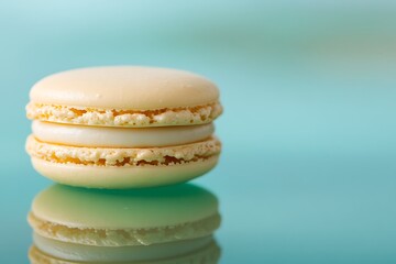 Pale yellow macaron resting on a flat mint green backdrop, with slight reflection and gentle highlight around the edges for a clean, airy feel 