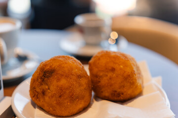 Italian café serving arancini with coffee