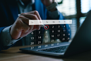 Businessman using a digital calendar interface on laptop to schedule appointment, plan event, manage tasks and organize work agenda. Concept of time management, reminder and productivity.