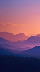 Sunset over mountain range, layers of purple and orange hues