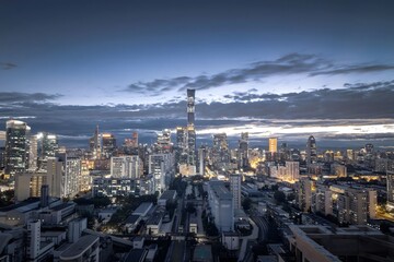 Aerial View of Beijing Guomao CBD Skyline at Twilight - China Urban Nightscape with Dramatic Sky and Glowing Buildings
