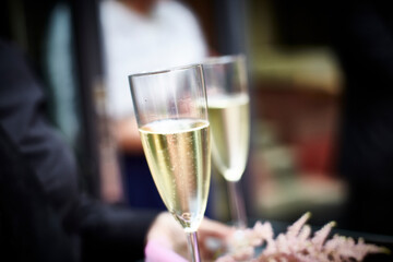 Waiter serving two glasses of champagne