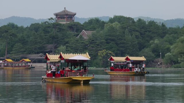 Traditional sightseeing boats travel on the lake, Chengde Mountain Resort, Hebei province, China.